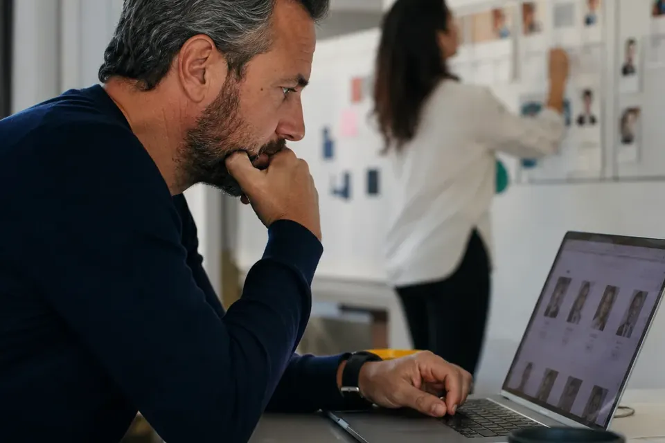 Chief people officer reviewing an org chart with a company founder at a meeting table