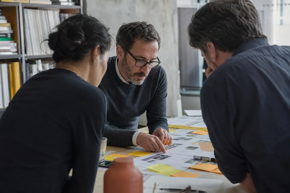Product leader planning a roadmap with sticky notes and two teammates